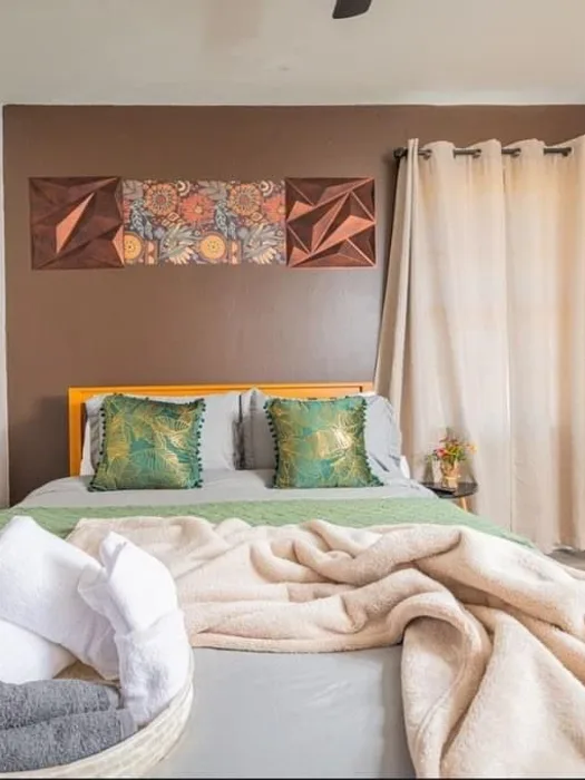 Bedroom with folded towel basket staged at the foot of the bed