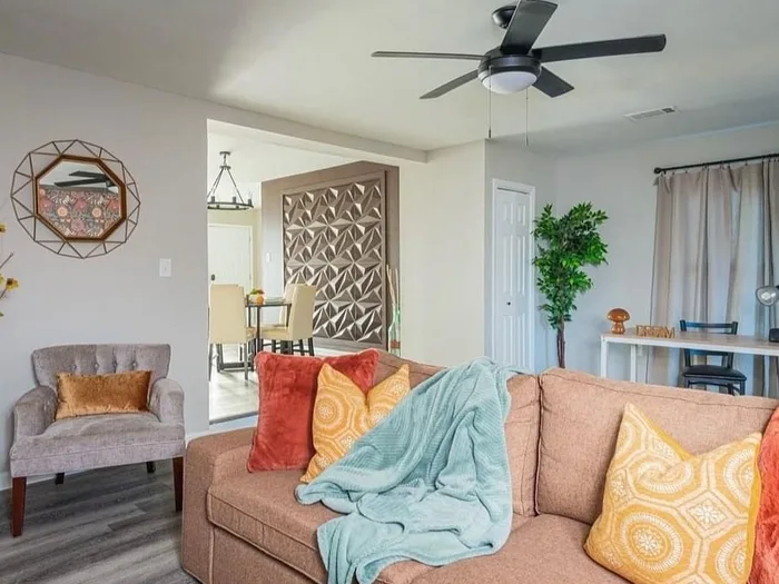 Living room with accent wall, cleaned couch and staged pillows